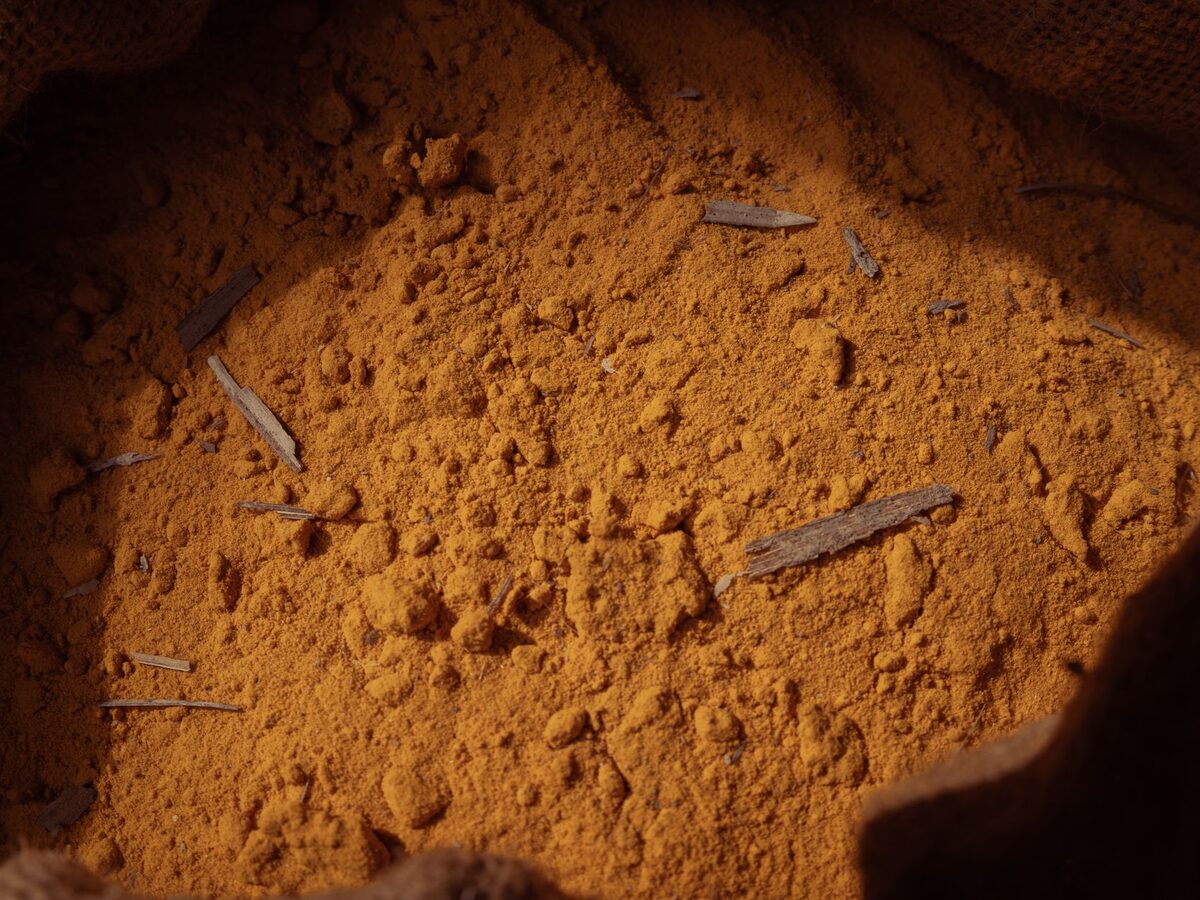 Ground turmeric spice in a natural burlap sack